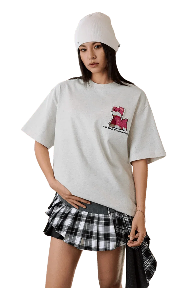 Casual outfit featuring the MEDM SS25 Cat Velcro Embroidery Tee with stylish layering and a plaid skirt