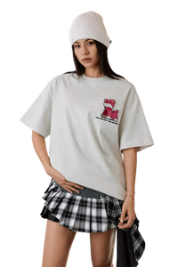 Casual outfit featuring the MEDM SS25 Cat Velcro Embroidery Tee with stylish layering and a plaid skirt