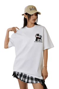 Model wearing the MEDM SS25 Cat Velcro Embroidery Tee in white featuring a playful cat design