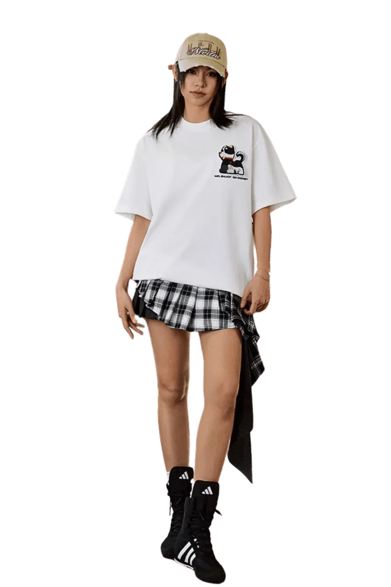 MEDM SS25 Cat Velcro Embroidery Tee in white paired with a plaid skirt and stylish accessories