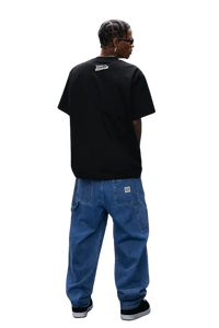 MEDM SS25 Dog Polaroid Tee in black worn with oversized denim pants for a trendy streetwear look