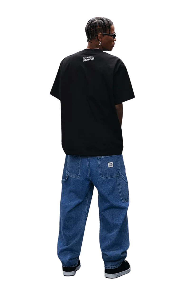 MEDM SS25 Dog Polaroid Tee in black worn with oversized denim pants for a trendy streetwear look
