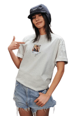 Model wearing a grey MEDM SS25 Dog Polaroid Tee with a vintage photo print, styled with denim shorts