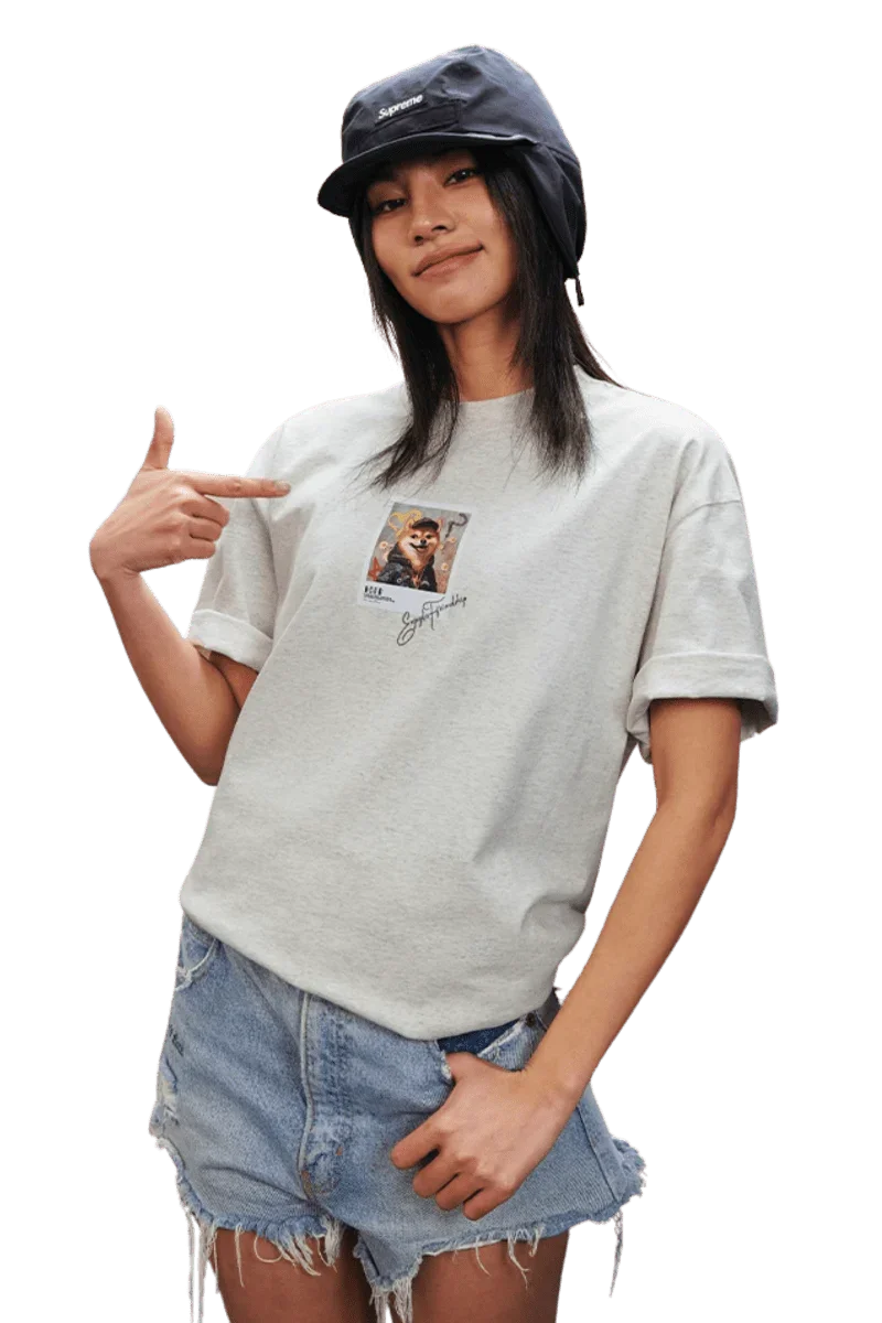 Model wearing a grey MEDM SS25 Dog Polaroid Tee with a vintage photo print, styled with denim shorts