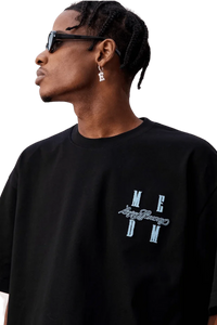 Model wearing MEDM SS25 Felt Embossed Basic Tee in black with stylish design and casual fit