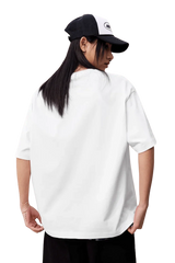 Back view of a model wearing the MEDM SS25 Felt Embossed Basic Tee in white with a cap
