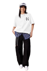 Model wearing the MEDM SS25 Felt Embossed Basic Tee with plaid shirt and relaxed pants