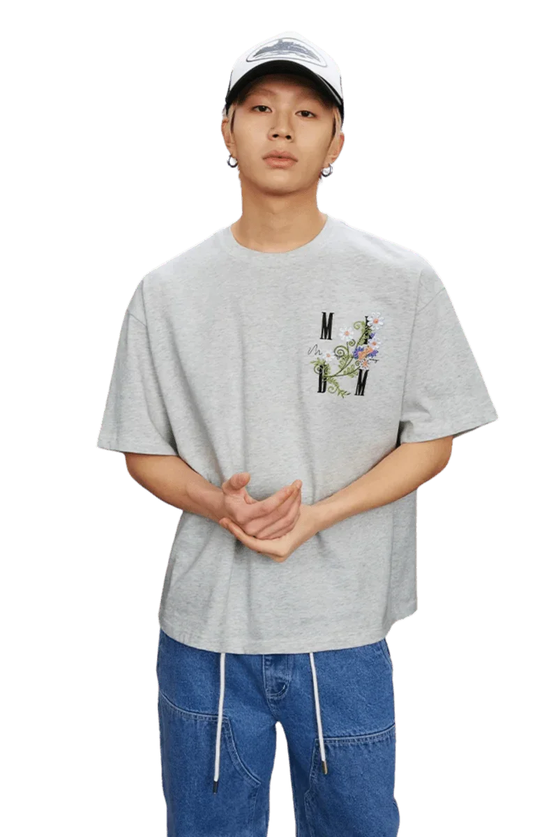 MEDM SS25 Floral Embroidery Tee in Gray featuring logo and colorful embroidery detail