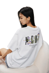 MEDM SS25 Floral Embroidery Tee in white featuring vibrant floral design on the back