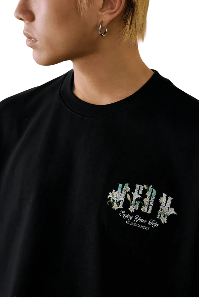 Close-up of the MEDM SS25 Floral Felt Embossed Tee featuring vibrant floral embroidery on a black shirt