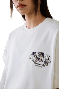 MEDM SS25 Floral Felt Embossed Tee in white with colorful floral embroidery for a stylish look