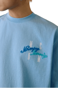 MEDM SS25 Four Color Velvet Embossed Tee in Blue with stylish logo detail