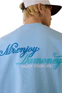 MEDM SS25 Four Color Velvet Embossed Tee in light blue featuring stylish embroidered text on the back