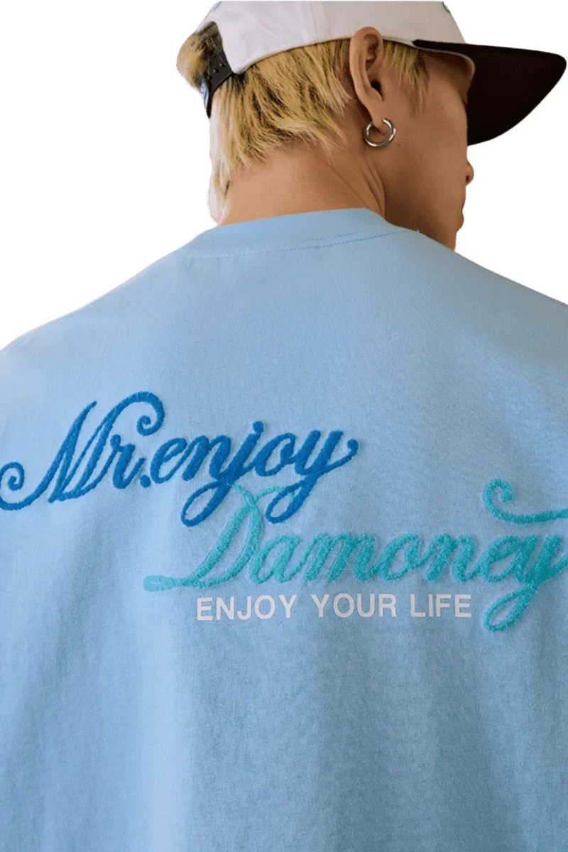 MEDM SS25 Four Color Velvet Embossed Tee in light blue featuring stylish embroidered text on the back