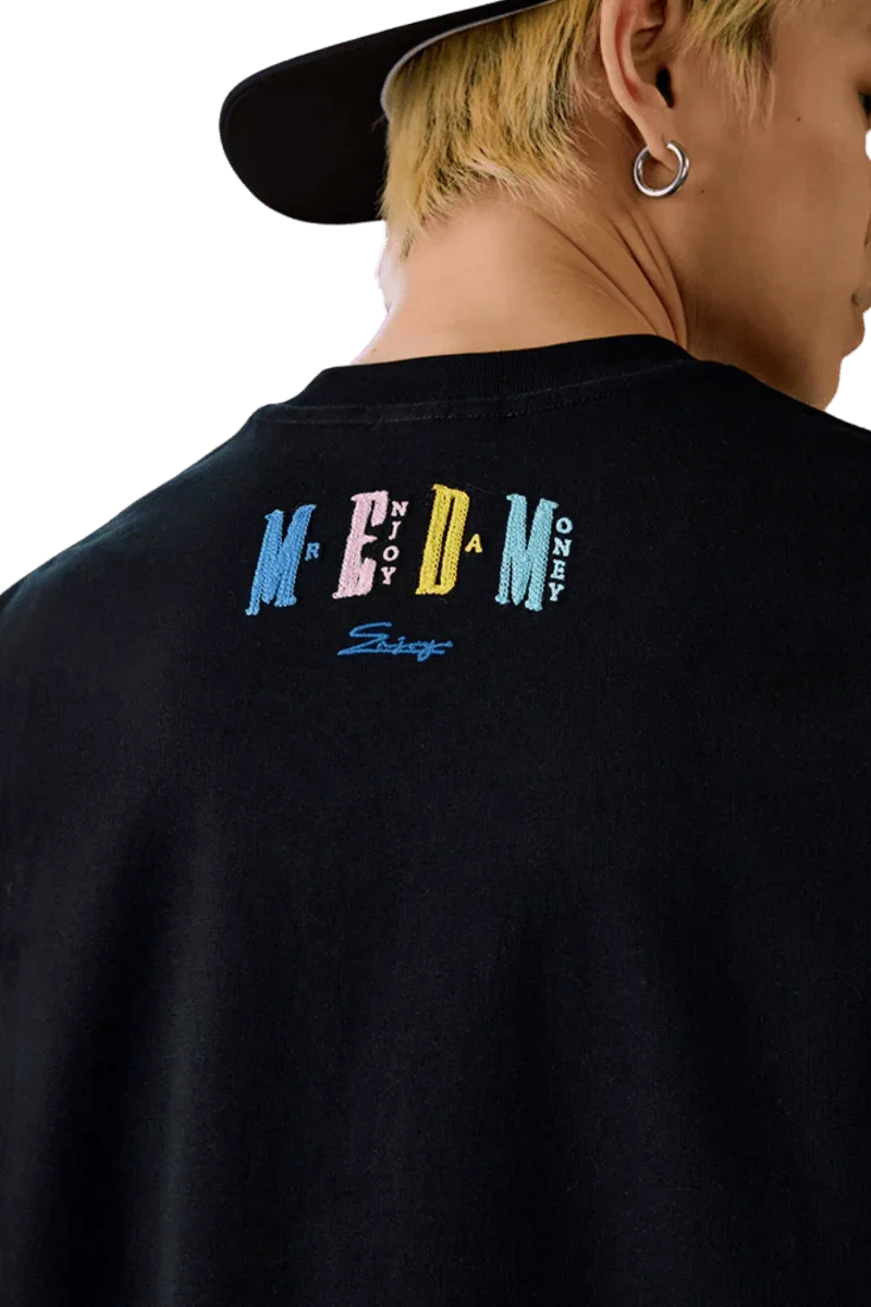 Black MEDM SS25 Macaron Velvet Embossed Tee featuring colorful logo on the back for a trendy look