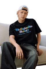Stylish MEDM SS25 Macaron Velvet Embossed Tee in black worn by a model with relaxed fit jeans