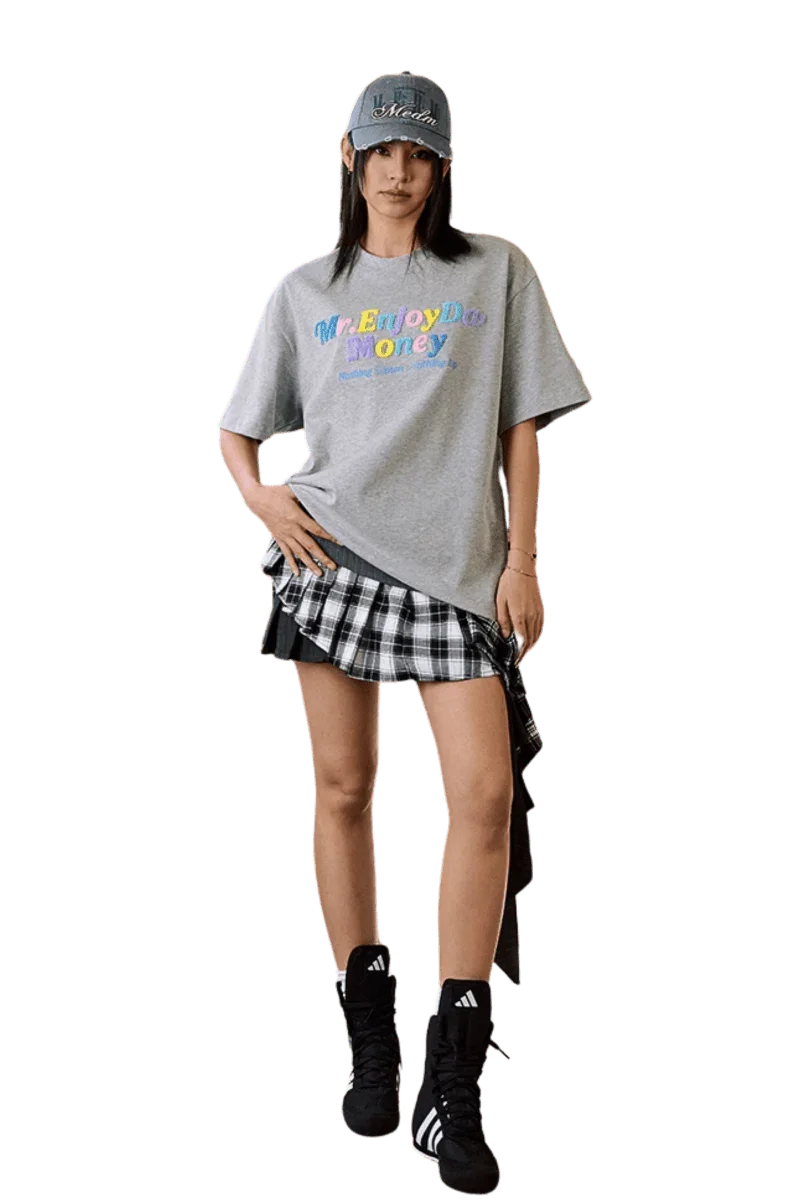 Model wearing MEDM SS25 Macaron Velvet Embossed Tee with a plaid skirt and accessories