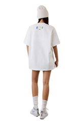 Model wearing the MEDM SS25 Macaron Velvet Embossed Tee in white with a relaxed fit and stylish design