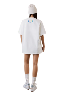 Model wearing the MEDM SS25 Macaron Velvet Embossed Tee in white with a relaxed fit and stylish design