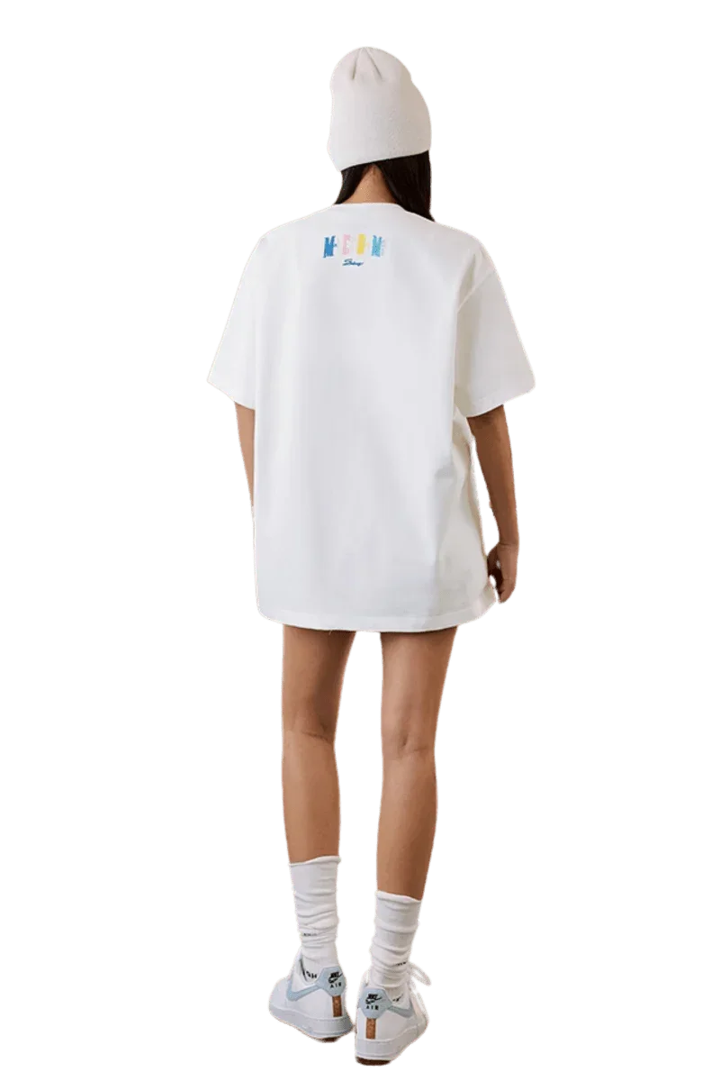 Model wearing the MEDM SS25 Macaron Velvet Embossed Tee in white with a relaxed fit and stylish design