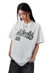 MEDM SS25 Rhinestone Tee in white featuring bold graphics and relaxed fit for stylish comfort