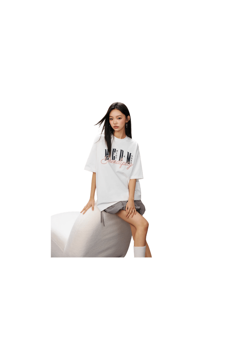 Model wearing MEDM SS25 Serendipity Embroidery Tee in white with stylish design and relaxed fit