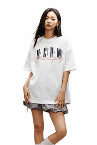 Model wearing MEDM SS25 Serendipity Embroidery Tee in white with stylish oversized fit