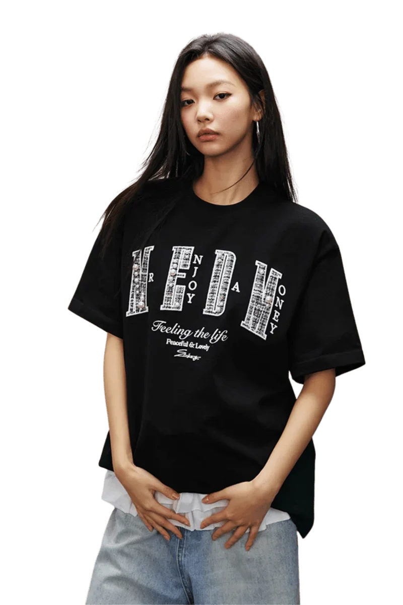 MEDM SS25 Small Pearl Tee in black featuring bold graphics and relaxed fit for casual style