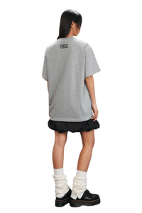 MEDM SS25 Small Pearl Tee in gray, worn with a black skirt and boots, showcasing a relaxed fit