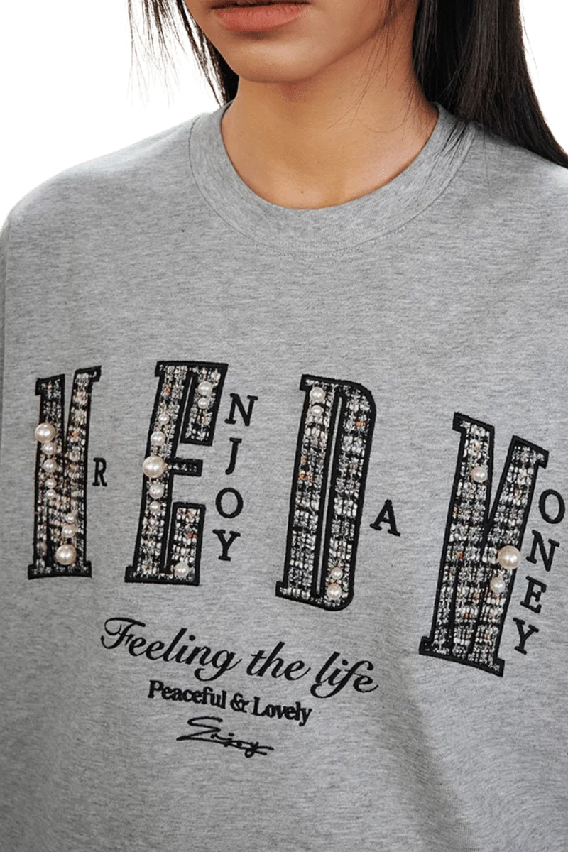 MEDM SS25 Small Pearl Tee in Grey with Pearl Embellishments and Bold Text Design