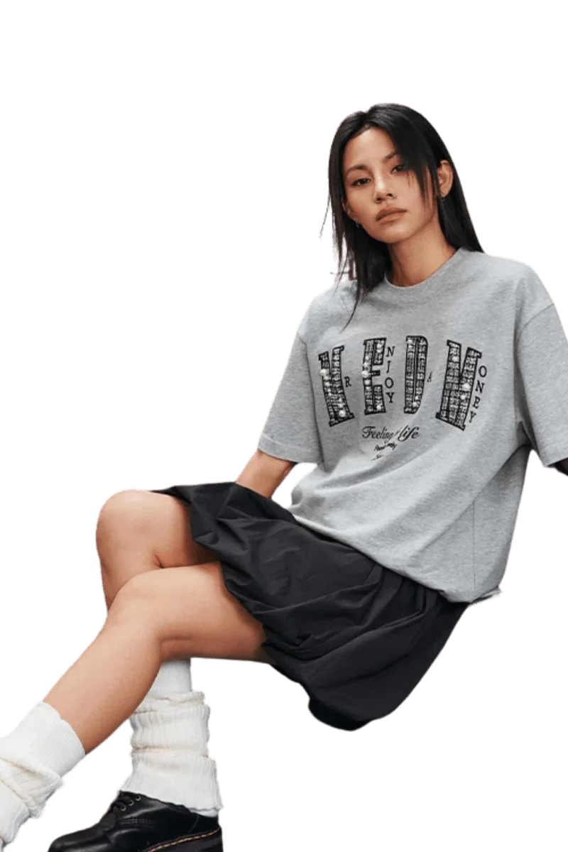 Model wearing the MEDM SS25 Small Pearl Tee in gray with graphic design and a relaxed fit