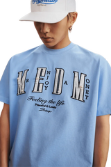 MEDM SS25 Small Pearl Tee in light blue featuring unique lettering and comfortable fit for casual wear