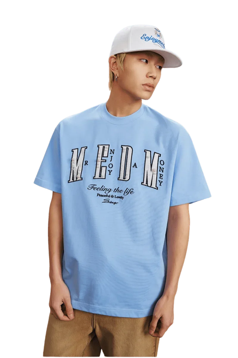 MEDM SS25 Small Pearl Tee in light blue with bold graphic design for casual style