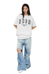 Model wearing MEDM SS25 Small Pearl Tee with distressed jeans for a trendy casual look