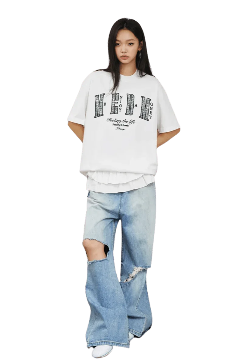 Model wearing MEDM SS25 Small Pearl Tee with distressed jeans for a trendy casual look