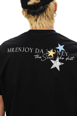 MEDM SS25 Snake Star Patch Tee featuring colorful star patches and a stylish graphic design on a black fabric