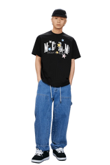 MEDM SS25 Snake Star Patch Tee in black worn with relaxed denim pants and sneakers
