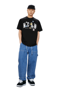 MEDM SS25 Snake Star Patch Tee in black worn with relaxed denim pants and sneakers
