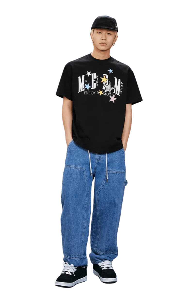 MEDM SS25 Snake Star Patch Tee in black worn with relaxed denim pants and sneakers