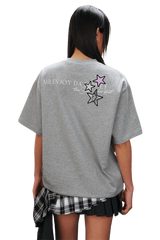 Back view of MEDM SS25 Snake Star Patch Tee in grey with colorful star patches and logo design
