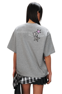 Back view of MEDM SS25 Snake Star Patch Tee in grey with colorful star patches and logo design
