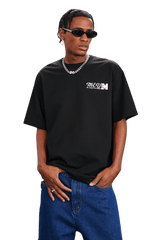 MEDM SS25 The Time Basic Logo Tee in Black Worn by Model with Sunglasses and Chain