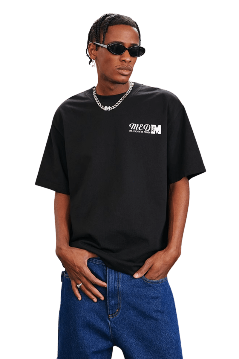 MEDM SS25 The Time Basic Logo Tee in Black Worn by Model with Sunglasses and Chain