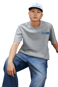 Model wearing MEDM SS25 The Time Basic Logo Tee in gray paired with casual jeans for a trendy look