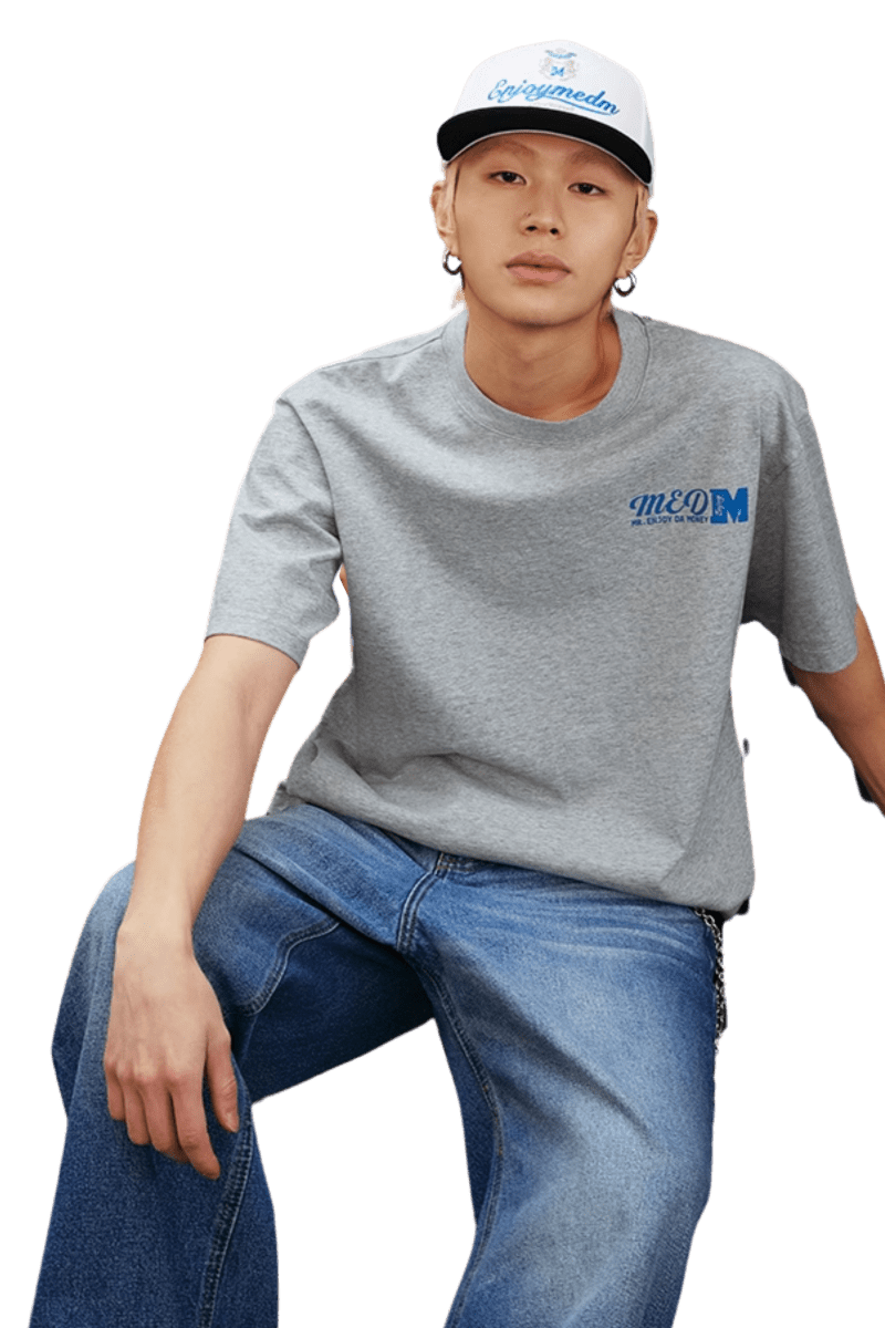Model wearing MEDM SS25 The Time Basic Logo Tee in gray paired with casual jeans for a trendy look