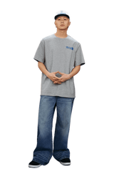 MEDM SS25 The Time Basic Logo Tee in grey, styled with relaxed denim jeans and a matching cap