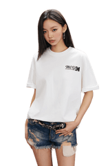 MEDM SS25 The Time Basic Logo Tee in White worn with distressed denim shorts for a casual look