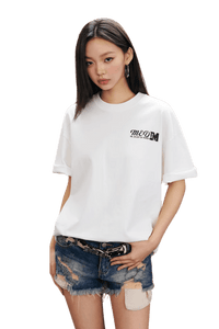 MEDM SS25 The Time Basic Logo Tee in White worn with distressed denim shorts for a casual look