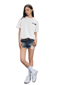 MEDM SS25 The Time Basic Logo Tee in white, paired with distressed denim shorts and sneakers