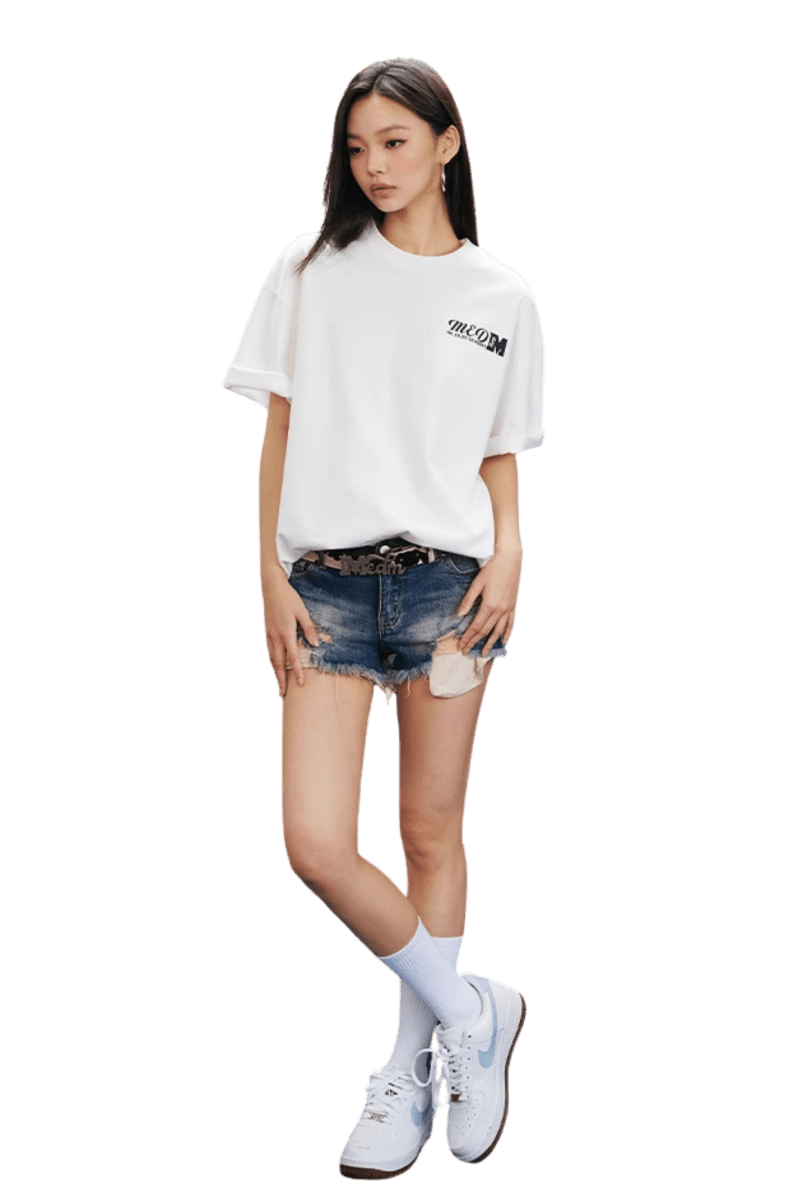 MEDM SS25 The Time Basic Logo Tee in white, paired with distressed denim shorts and sneakers
